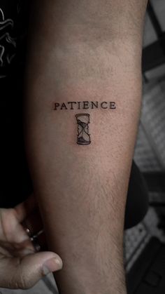 a person with a tattoo on their arm that says,'pattence '