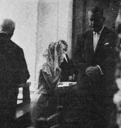 black and white photograph of three people sitting at a table