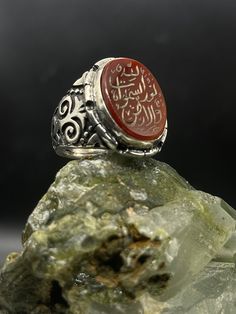 A silver ring made in the old Ottoman way. Inlaid with Yemeni agate stone. The ring is completely handmade and engraved on the stone with the distinctive Arabic. We offer special handmade products suitable for women and man, They can be used as a nice gift for any event or occasion. we have a variety of designs and shapes. our clients can decide how they want their product to be, as we can put any text, number or name on the product. Our products are made by passion & 20 years of experience. Our products are guaranteed for Lifetime. Our products can be weared every day (24/7) Our products can be personalized depending on the client's requests Our products come with an Elegant & modern box which suits all occasions. ✦ Item Details ✦ * Finish: Oxidized  * Material: 925k Sterling Silver  * Co Artisan Engraved Signet Ring Gift, Artisan Engraved Signet Ring For Gift, Silver Agate Signet Ring For Gift, Traditional Oval Engraved Signet Ring, Traditional Engraved Oval Signet Ring, Traditional Silver Agate Ring, Artisan Oval Engraved Ring, Traditional Carved Signet Ring Gift, Traditional Carved Signet Ring For Gift