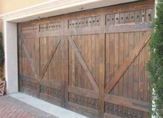 a large wooden garage door in front of a house