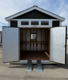 an empty storage shed with the doors open