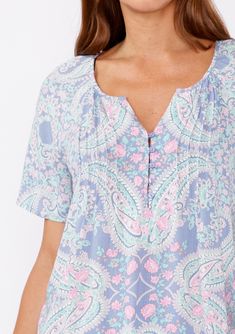 Embrace effortless style with our adorable paisley print bohemian top, a perfect blend of comfort and elegance. Featuring a relaxed fit that drapes beautifully, ensuring you stay comfortable all day long. The delicate paisley print adds a touch of vintage charm, while the pastel hues create a trendy and stylish look. Paisley print Relaxed fit Short sleeve Split v-neckline Button front Pintuck details Flowy bohemian top Crafted with the bohemian spirit in mind, this top is a must-have for those w V-neck Floral Print Loungewear Blouse, Feminine Floral Print Top With Split Neck, Floral Print Patterned Tops For Loungewear, Bohemian V-neck Blouse For Loungewear, Short Sleeve Blouse With Floral Print For Loungewear, Bohemian Relaxed Fit Blouse For Loungewear, Bohemian Floral Print Tops For Loungewear, Bohemian Printed Tops For Daywear, Bohemian Short Sleeve Paisley Print Tops