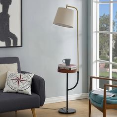 a living room with a chair, table and lamp