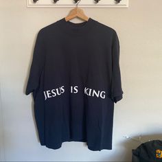 a t - shirt that says jesus is king hanging on a wall