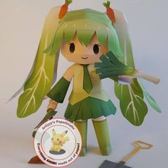 a paper doll with green hair holding a leaf