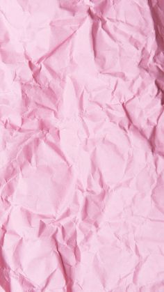 pink crumpled paper is shown in close up