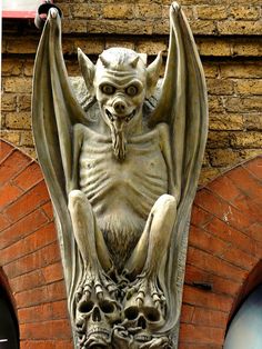 a gargoyle statue on the side of a building