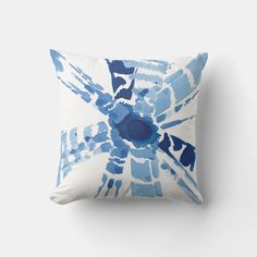 a blue and white pillow sitting on top of a wall