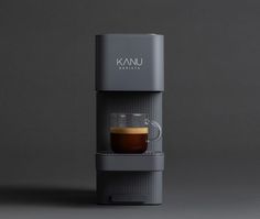 a coffee maker with a cup in it