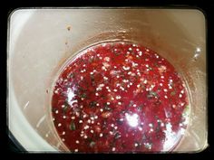 a bowl filled with red liquid and sprinkles