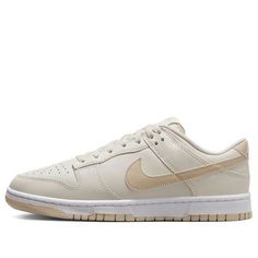 The Nike Dunk Low 'Light Bone Tan' is a stylish sneaker crafted from full-grain leather with a mesh tongue and lining. The Light Bone base is complemented by tan Swooshes, heel, tongue branding, insoles and rubber outsole. The white midsole and heel feature a white “NIKE” embroidered branding. This sneaker is perfect for everyday wear and is inspired by the classic Dunk series. The tan colorway adds a subtle touch of style to any outfit. With its timeless design, the Nike Dunk Low 'Light Bone Tan' is sure to be a hit. Nike Sneakers With Rubber Sole, Sporty Cream Sneakers With Rubber Sole, Classic Cream Sneakers For Streetwear, Cream Sneakers With Rubber Sole For Sports, Cream Leather Sneakers With Translucent Outsole, Urban Cream Sneakers For Streetwear, Beige Sports Sneakers With Rubber Sole, Beige Low-top Sneakers With Boost Midsole, Cream Sneakers With Rubber Sole For Light Sports