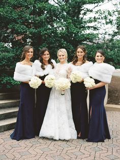 the bride and her four bridesmaids pose for a photo