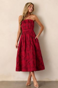 This elegant Moonstone Dreams Ruby Red Floral Jacquard Midi Dress features a stunning floral design and a comfortable strapless neckline. Perfect for any occasion, it will make you feel confident and stylish. Let the simmering jacquard fabric embrace you as you dance the day or night away. This red dress features a pleated bodice, a slightly pleated skirt, functional hip pockets, a smocked back, a discrete back zipper and a strapless design.  82% Polyester & 18% Nylon  Unlined  Hand Wash Cold  Manufactured in China  Designed in The USA  Model is wearing a size small  Model is 5'8" Preppy Girls, Rush Dresses, Strapless Neckline, Strapless Midi Dress, Pleated Bodice, Dress Bra, Floral Jacquard, Women's Shapewear, Long Crop Top