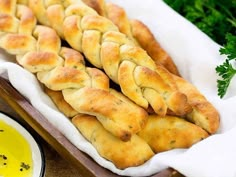 some bread sticks sitting on top of a wooden tray