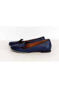 These blue flats have a gold trim around the front. Made with durable leather, they are a chic pair of shoes that can be worn during the day. Size 7.5 Leather upper & sole Slip on Rounded toe Heavy outsole wear Some scuffs on toe by sole Heel height .5" Outsole length 10" Slip-on Flats With Contrast Sole, Blue Loafers With Contrast Sole Slip-on, Blue Slip-on Loafers With Contrast Sole, Classic Blue Flats For Work, Blue Classic Flats For Work, Classic Blue Flats For Workwear, Classic Blue Slip-on Flats, Classic Blue Closed Toe Flats, Blue Classic Closed Toe Flats