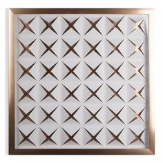 a white and gold framed wall hanging with crosses on it's side, against a white background