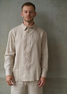 This classic linen shirt is a must-have for all seasons. Made from softened European linen, it feels amazing on your skin. The shirt is super versatile--perfect for the office, the beach, or a casual stroll in the city. Its relaxed fit makes it easy to pair with anything, and it always looks classy, elegant, and modern. Whether you wear it on its own or layer it, this shirt is your go-to for a timeless and refined look. DETAILS:  - Loose Fit - Long Sleeves - Dropped Shoulders - Button-down shirt  - Sea Shell Buttons - Various Colors Available - 100% lightweight European linen fabric - Hand-Made in our small studio in Siauliai, Lithuania SIZE IN THE PICTURE: The model is wearing size L. The Model's height is 185cm (6'1 ft). CARE:  Washing: Hand wash or machine wash on a gentle cycle in cold Siauliai Lithuania, Long Sleeve Linen Shirt, Shirt Linen, Linen Clothing, Men Classic, European Linens, Small Studio, Shirt Long Sleeve, Oversized Shirt