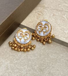 Polki earrings feature mother of pearl and Kundan work with an antique gold stud design. Perfect for Bollywood weddings, they showcase traditional Jadau craftsmanship, making them a stunning statement for Pakistani jewelry. *𝐏𝐑𝐎𝐃𝐔𝐂𝐓 𝐃𝐄𝐓𝐀𝐈𝐋* * Material: Brass * Plating: Gold Plated * Stone: Semi Precious Carved Stone & Polki. *𝐃𝐈𝐌𝐄𝐍𝐒𝐈𝐎𝐍𝐒* * Weight: 12 gm   * Length: 1.5 Inches, Width: 1.05 Inches Closure: PushBack. *𝐃𝐈𝐒𝐂𝐋𝐀𝐈𝐌𝐄𝐑* * Product color may slightly vary du Luxury Meenakari Temple Jewelry Pearl Earrings, Traditional 22k Gold Bridal Earrings For Festive Occasions, Elegant Meenakari Chandbali Pearl Earrings, Antique Gold Festive Earrings, Festive Antique Gold Earrings, White 22k Gold Chandbali Earrings, Traditional Brass Chandbali Bridal Earrings, Elegant Pearl Meenakari Earrings For Diwali, Traditional Bridal Chandbali Earrings In Brass