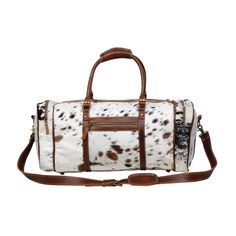 For the love of travel and style this Amore Duffel is specially important. A gracious space to pack the amount of items you may need as well as a durable and stylish bag for a professional business trip, or a weekend long getaway. Full body covered in brown and white hair-on hide and light brown leather trim. Leather padded straps for added comfort. Importantly, this bag is engineered to be light for the traveller on the go. Materials Leather & HaironItem Width 24"Item Depth 9.5"Item Height 10"Handle 9.5"Shoulder 30.5" Note that the exact pattern of the hair-on hide, and leather as pictured may vary slightly due to the crafted nature of the item. Western Bags Purses, Western Bags, Travel Luggage Set, Western Bag, Cowgirl Accessories, Leather Duffel Bag, Leather Duffel, Cowhide Bag, Metallic Purse