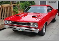 a red car parked in front of a house