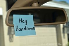 a sticky note attached to the side mirror of a car with hey handsome written on it