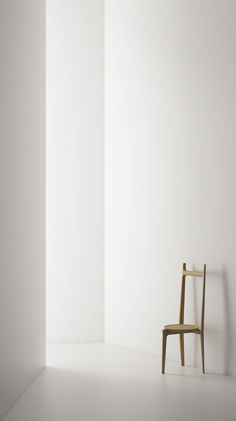 a chair sitting in front of a white wall