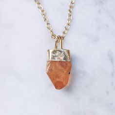 Enchanting Tangerine Quartz raw stone energy necklace in 24K gold plated over brass. Available in women's and men's chain lengths. The Tangerine Quartz stimulates the joyful energy of the inner child, activating playfulness, curiosity and passion. The raw stone crystal will vary slightly in shape, size and color. Crystal Sizes Medium (1 - 1.25 inches) Large (1.25 plus inches) Chain length 16 inches / 40.6 cm 18 inches / 45.7 cm 23.5 inches / 60 cm 31.5 inches / 80 cm Available in 925 Sterling Si Tangerine Quartz, Stone Energy, Energy Jewelry, Crystal Point Necklace, Boho Layering, Necklace For Men, Layering Necklace, Crystal Necklace Pendant, Quartz Necklace