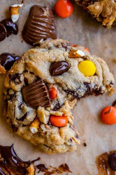 chocolate chip cookies with m & m candies and candy on the top one cookie has been cut in half