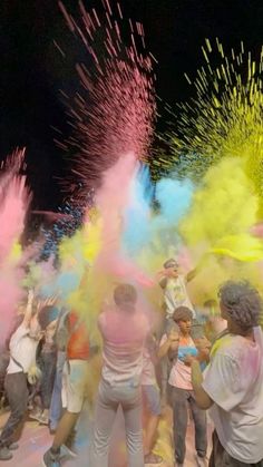 people are throwing colored powder on each other