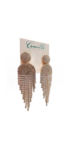 The Button Post Graduated Rhinestone Earrings feature rhinestone buttons with tassle-like dangle and back post closures. Wear these earrings adorningly to your next wedding, or formal evening event! Silver Tassel Earrings With Rhinestone Fringe, Silver Rhinestone Fringe Tassel Earrings For Party, Glamorous Gold Tassel Earrings With Rhinestones, Glamorous Metal Tassel Earrings For Party, Gold Rhinestone Tassel Dangle Earrings, Silver Tassel Earrings With Rhinestones For Party, Gold Tassel Dangle Earrings With Rhinestones, Glamorous Silver Tassel Earrings With Rhinestones, Metal Tassel Earrings For Wedding