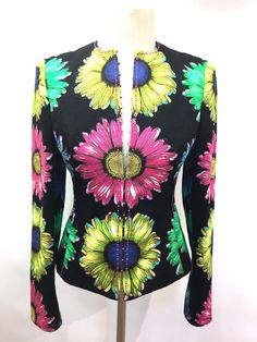 GIANNI VERSACE Black/Multicolor Floral-Print Cotton Jacket Size: 4 Description & Details: 100% Cotton Cropped Fitted Style Collarless Multiple Hook & Eye Closures Pink Embroidery Around Front and all Seams Slits at Back Sides Slits at Cuffs No Pockets Black Medusa-Patterned Lining Made in Italy Measurements: Size: 4 Length: 21.5" Bust: 32" Shoulder-to-shoulder: 15” Sleeve: 23.75" Condition: Minimal signs of wear. Excellent preowned condition. BIS Designer Resale receives all of our items Pink Embroidery, Best Kept Secret, Gianni Versace, Large Flowers, Cotton Jacket, Flower Print, Flower Prints, Vest Jacket, Printed Cotton