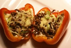 two stuffed bell peppers on a white plate