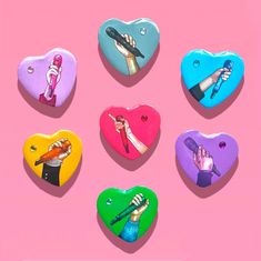 six heart shaped magnets with different colored hands holding microphones in each one, on a pink background