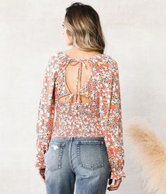 Willow & Root Floral Smocked Top - Orange Small, Women's Orangemulti Knit front and back tie top Elasticized ruffle cuffs Bust measures 29 on size small Body length 20 on size small Model Info: Height: 5'6 | Bust: 30 | Waist: 24 | Hip: 35 | Wearing Size: Small. Self: 96% Polyester 4% Spandex. Trim: 90% Nylon 10% Spandex. Hand wash cold. Do not bleach. Lay flat to dry. Cool iron if needed.. Measurements: Bust -Fullest part of bust with arms at sides. Waist -Circumference of natural waist: above b Knit Front And Back, Back Tie Top, Smocked Top, Waist Circumference, Top For Women, Women Shirts Blouse, Tie Top, Shirts Blouses, Women's Shirts