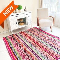 a colorful rug with an orange arrow over it and a white chair in the background