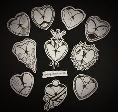 several heart shaped stickers on a black surface