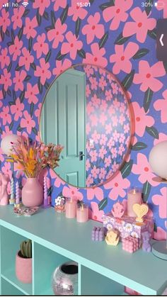 a room with pink and blue flowers on the wall