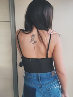 a woman with a rose tattoo on her back