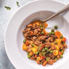 a white bowl filled with meat and vegetables