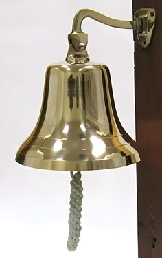 an old brass bell hanging from a wall