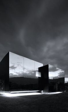 an image of a black and white scene with mirrors in the grass at night time