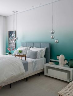 a bedroom with blue walls and white bedding