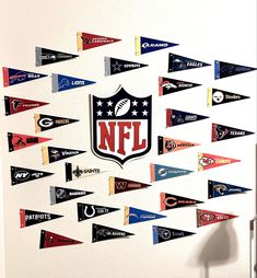 the nfl logo is displayed on a wall with many pennants hanging from it's sides