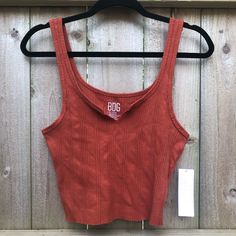 Nwt Bdg Urban Outfitters Rust-Colored Sleeveless Cropped Tank Top. Ribbed Texture. Factory “Cut-Off” And Notched At The Neck. Fabric Has A Ton Of Stretch. New With Tags And No Flaws. Size L. Length: 18.5” P2p: 14.5” (Stretches To 20”) Waist: 13.5” (Stretches To 19”) Trendy Red Ribbed Tank Top, Casual Red Tank Strap Tops, Red Ribbed Sleeveless Crop Top, Red Ribbed Sleeveless Top, Red Sleeveless Ribbed Crop Top, Red Sleeveless Ribbed Tops, Casual Ribbed Cropped Camisole, Bdg Urban Outfitters, Rust Orange