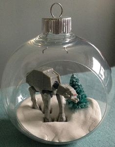 a glass ornament with a toy elephant in it