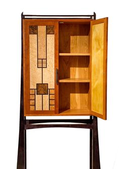 an open wooden cabinet with stained glass panels on the door and shelves in it, against a white background