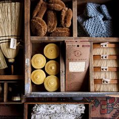 an open wooden box filled with different types of yarns and other things to sew