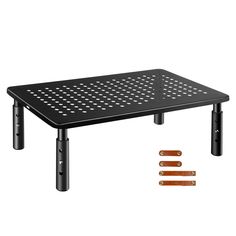 a black table with three legs and four holes