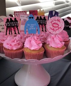 cupcakes with pink frosting on a cake plate