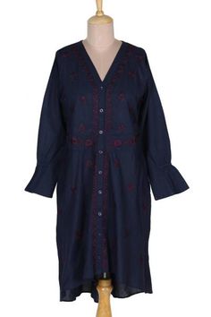 Maroon flowers bloom profusely on a background of navy blue in this pretty high-low shirtdress from designer Shalabh in India. Artisans craft the long-sleeved dress of 100% cotton and cover the front with traditional chikankari embroidery blossoms. An embroidered button placket and waistline further accent the dress. Long Sleeve Shirt Dress With Floral Embroidery For Spring, Long Sleeve Floral Embroidery Shirt Dress For Spring, Embroidered Long Sleeve Shirt Dress For Spring, Spring Long Sleeve Embroidered Shirt Dress, Spring Floral Embroidery Long Sleeve Shirt Dress, Spring Embroidered Long Sleeve Shirt Dress, Blue Cotton Dress With Embroidered Hem, Blue Folk Dress With Resham Embroidery, Indigo Cotton Dress With Buttons